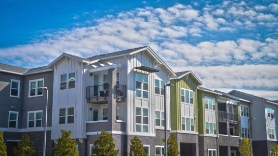 A row of colorful apartment buildings is seen from an angle view.