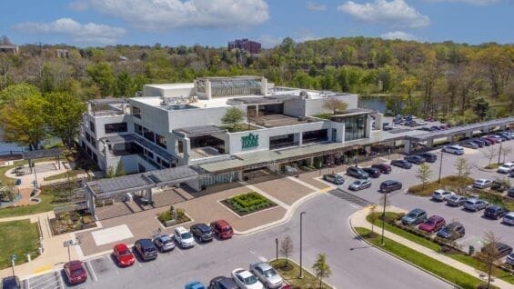 An aerial shot of a Whole Foods building and parking lot.